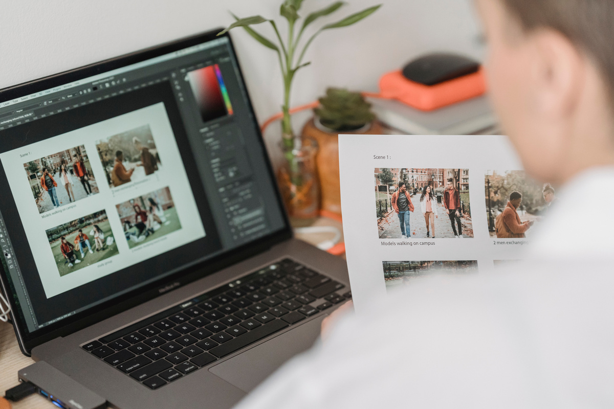 Woman working with laptop and photos